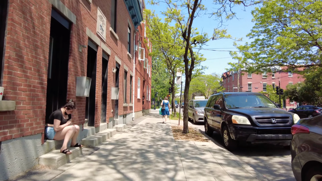 A Pointe-St-Charles resident sits out on the steps of her home in July 2024.