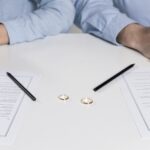 Image of a couple getting ready to sign divorce forms