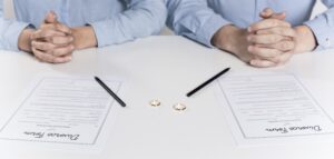 Image of a couple getting ready to sign divorce forms