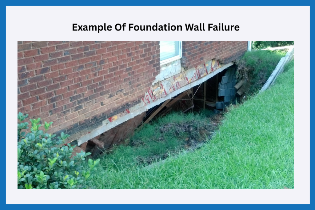 An image showing a concrete block foundation that has collapsed due to hydrostatic pressure.